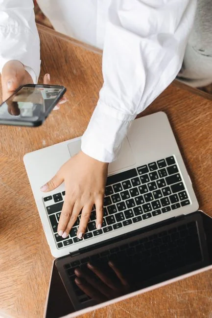 A person using a laptop to review social media marketing strategies at home.